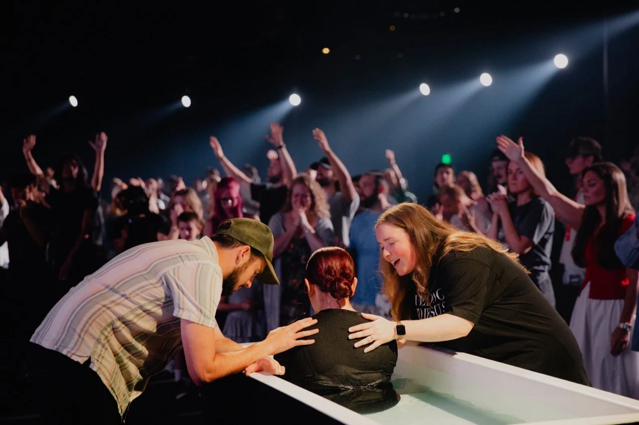 A person being baptized at The Belonging Co